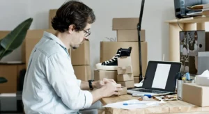 ecommerce entrepreneur building a branded business with product packaging and laptop workspace