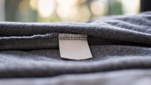 Blank sewn-in garment tag and seam showing an attachment position for care labels