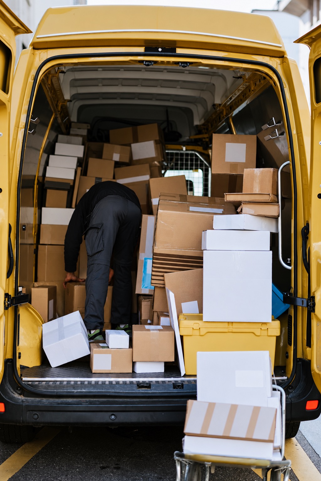 Parcels inside an open delivery van illustrating one stage of the transport journey
