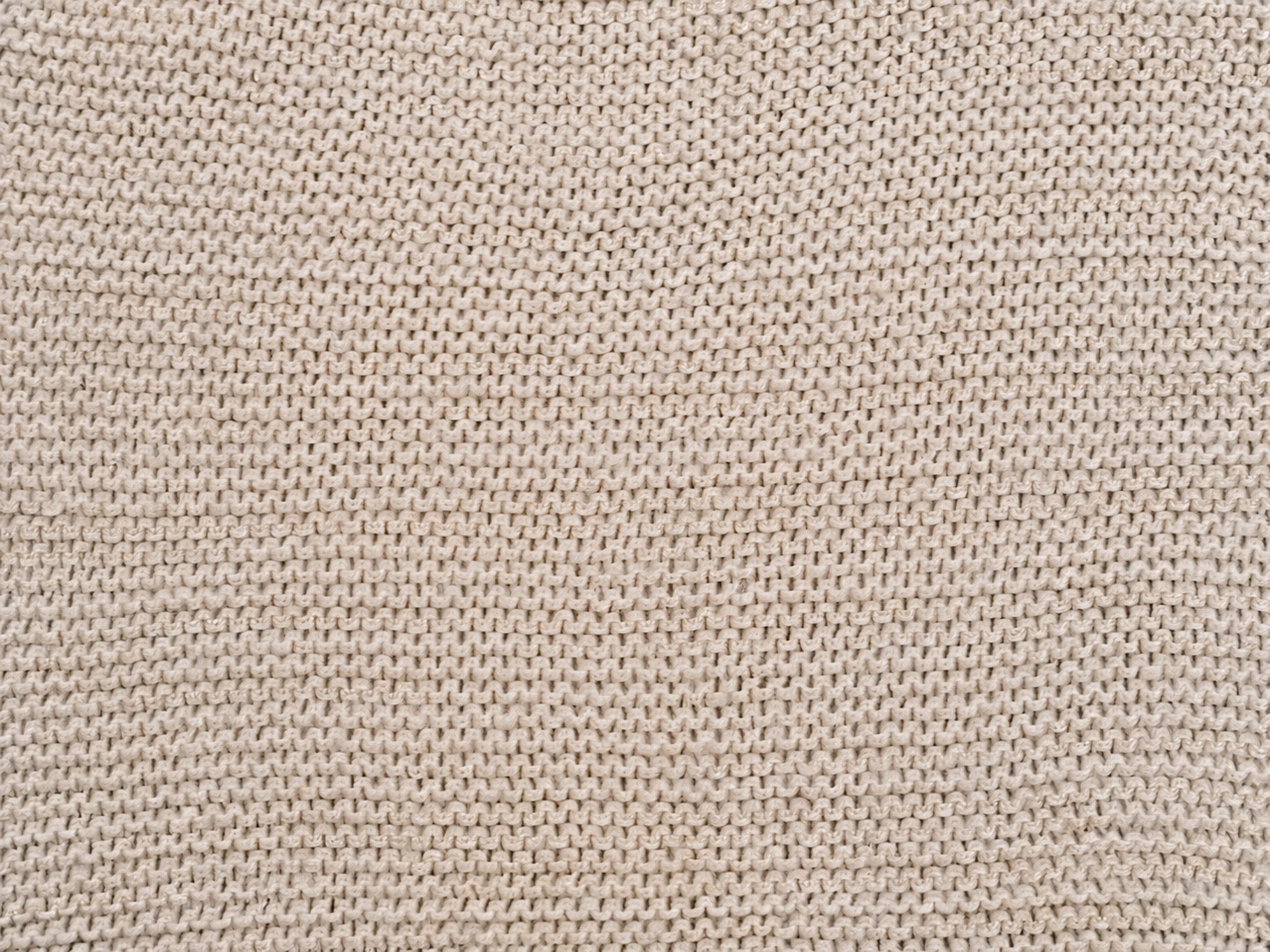 Close-up of interlocking knitted loops illustrating fabric construction without identifying fiber composition