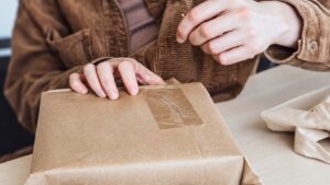 Hands working on a kraft-wrapped parcel before the order cancellation cutoff