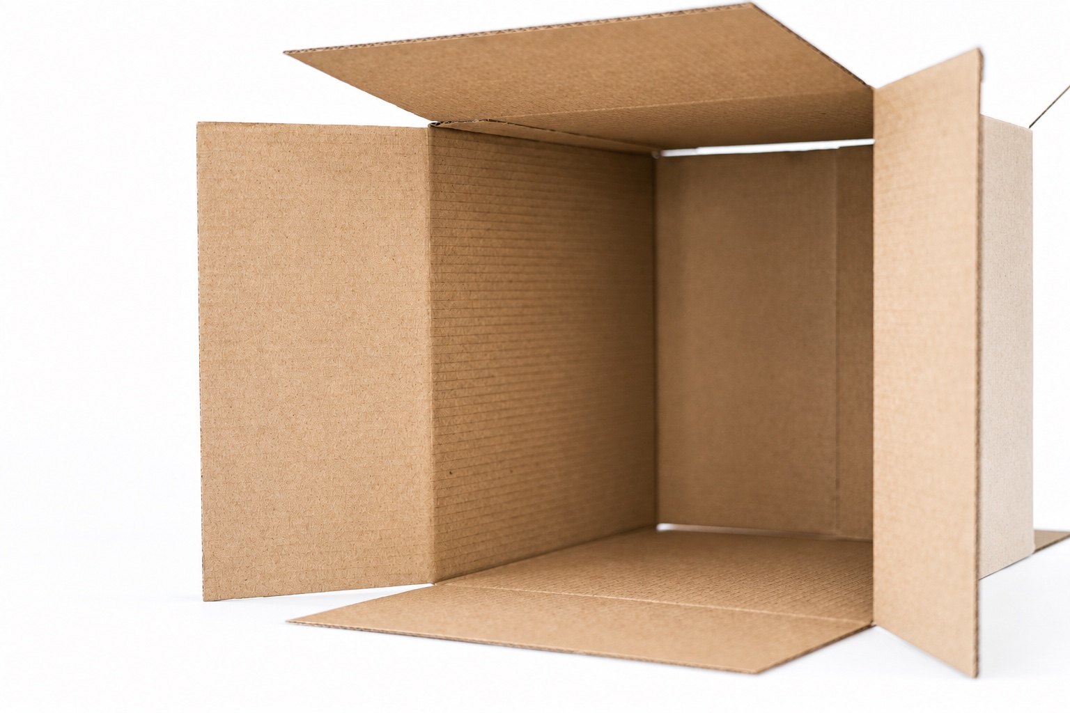 Open empty cardboard carton showing internal space and four folding flaps