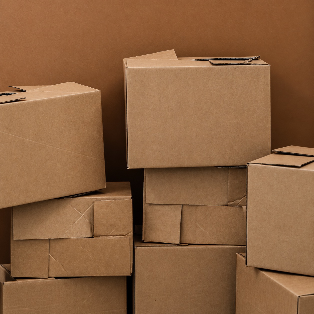 Stacked plain cardboard boxes with no visible order identifiers