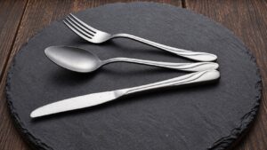 Silver fork, spoon and knife with bright edge highlights for reflective product photography