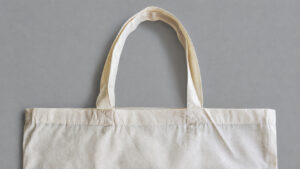 Handle attachments and upper hem in cream tote bag fabric