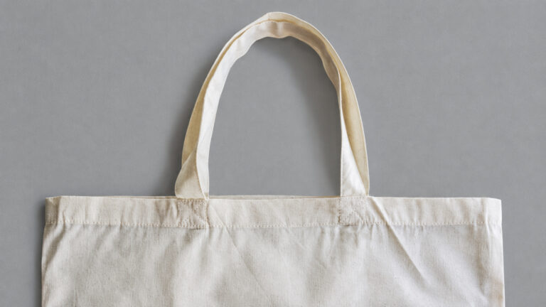 Handle attachments and upper hem in cream tote bag fabric