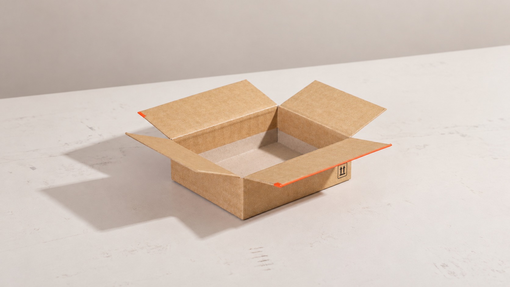Open kraft carton with handling arrows and protective packaging space