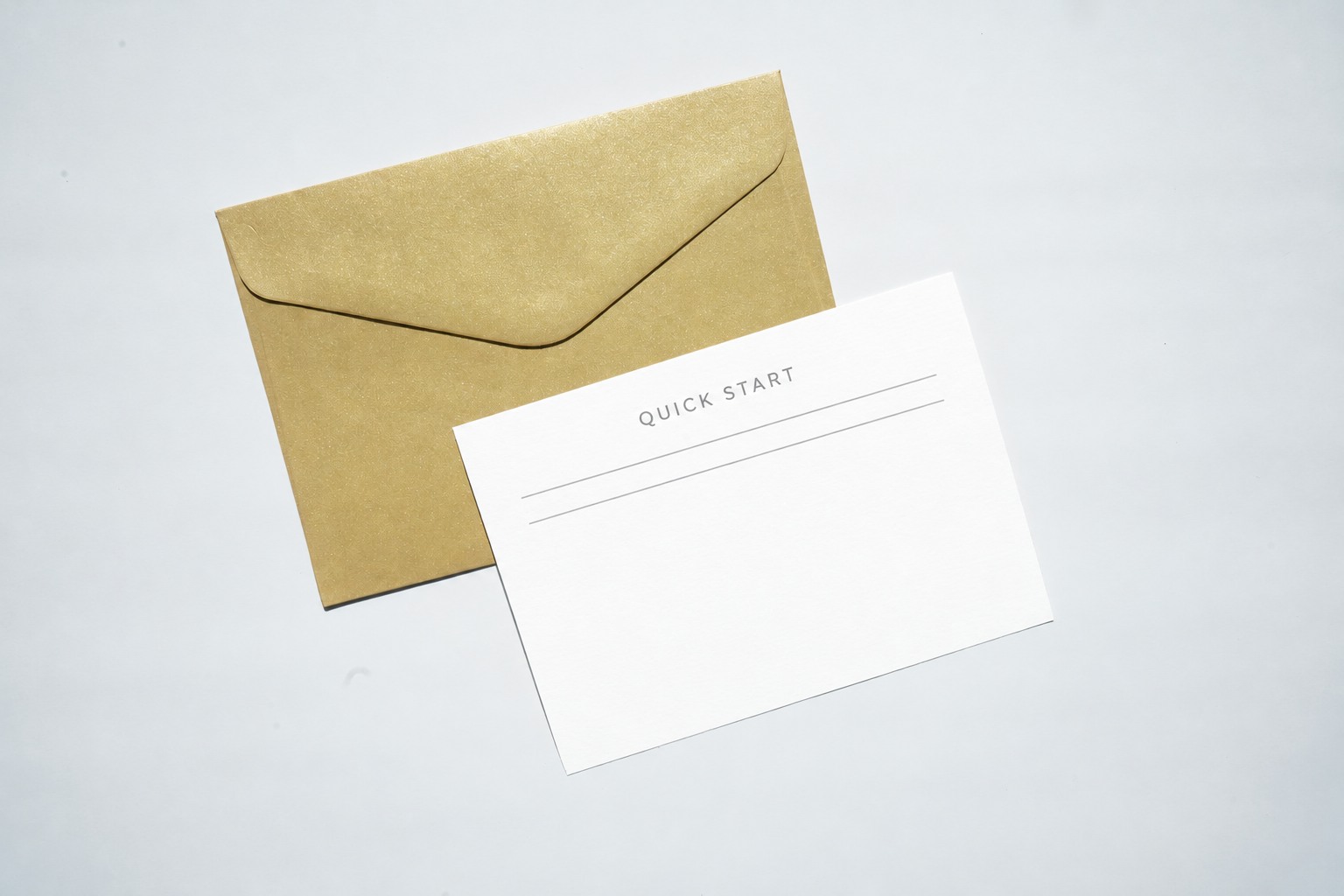 Separate quick-start card lying over a kraft envelope