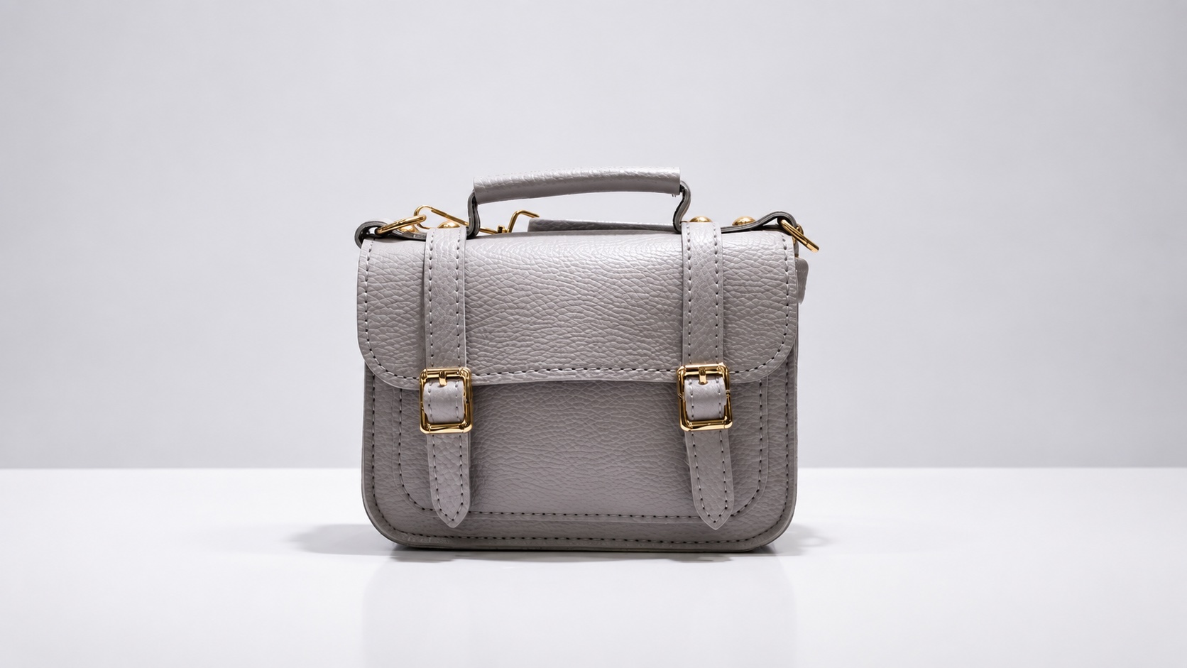 Front view of a gray bag with a top handle, showing why bag strap length cannot be judged from this view