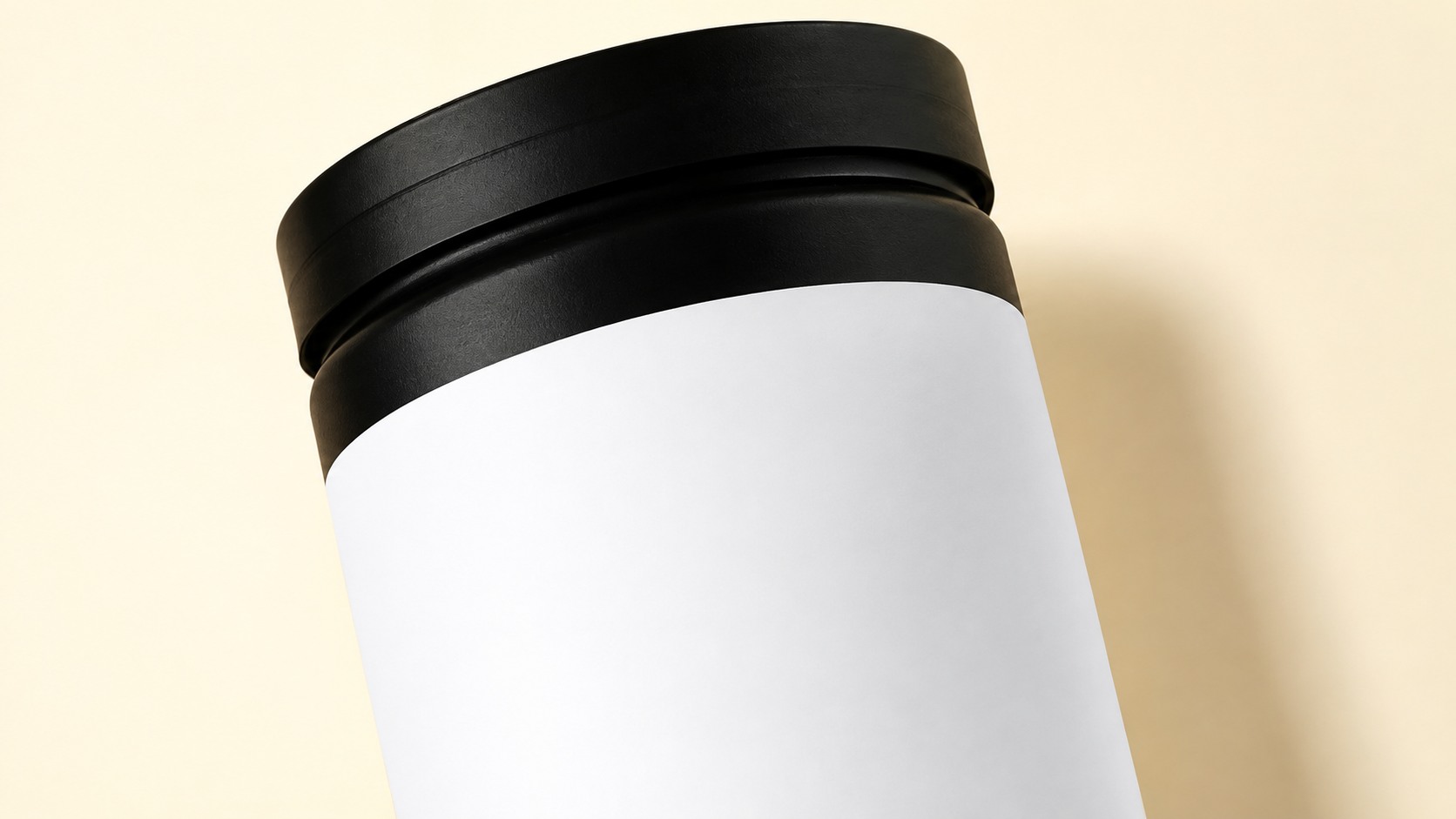 Close view of a black jar cap and blank white product label
