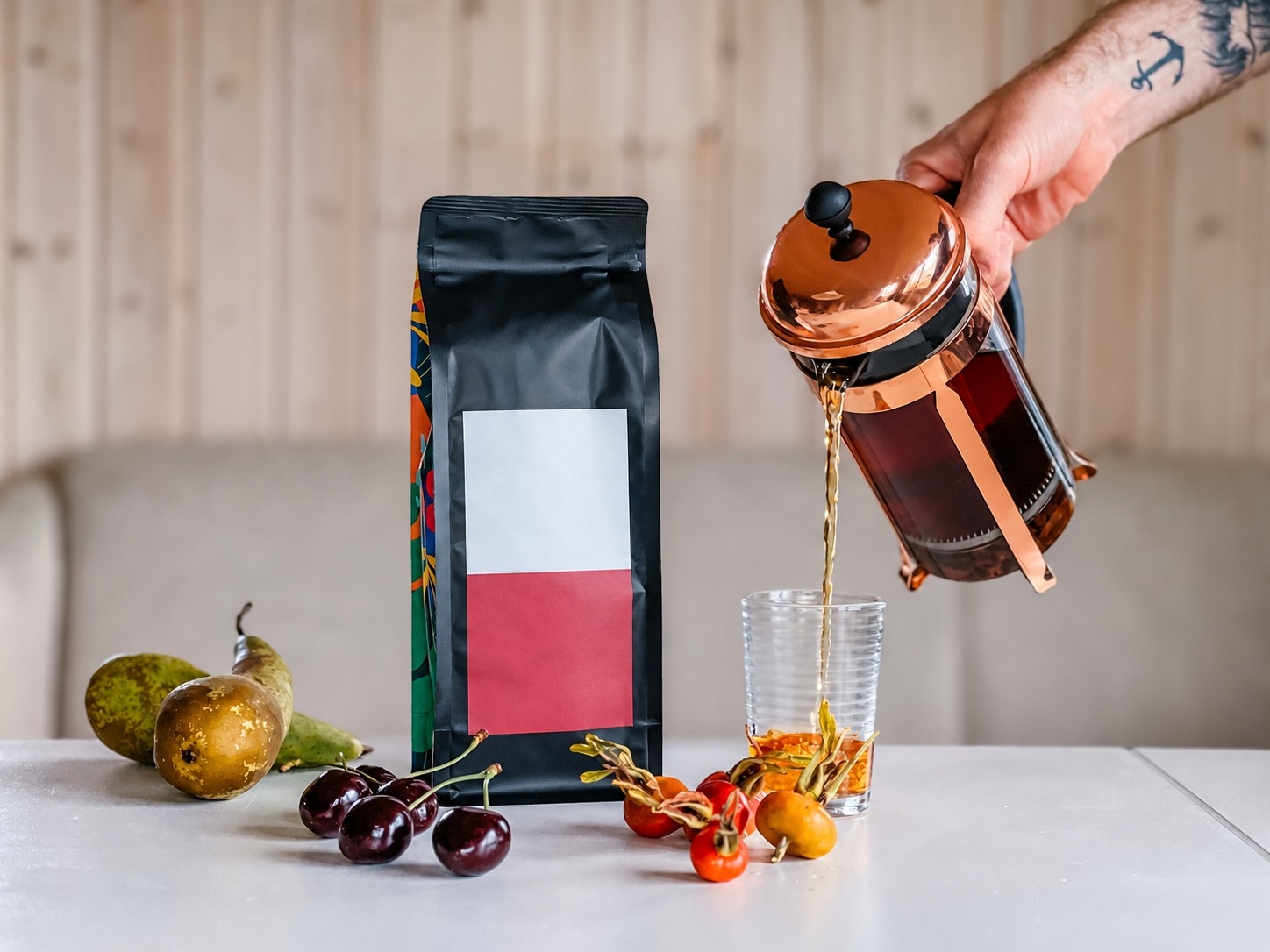 Hand pouring from a copper-framed press into a glass illustrating an action that does not establish direct-heat suitability