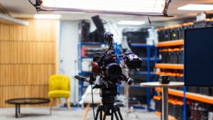 Studio camera on a tripod illustrating the production of exclusive product photos
