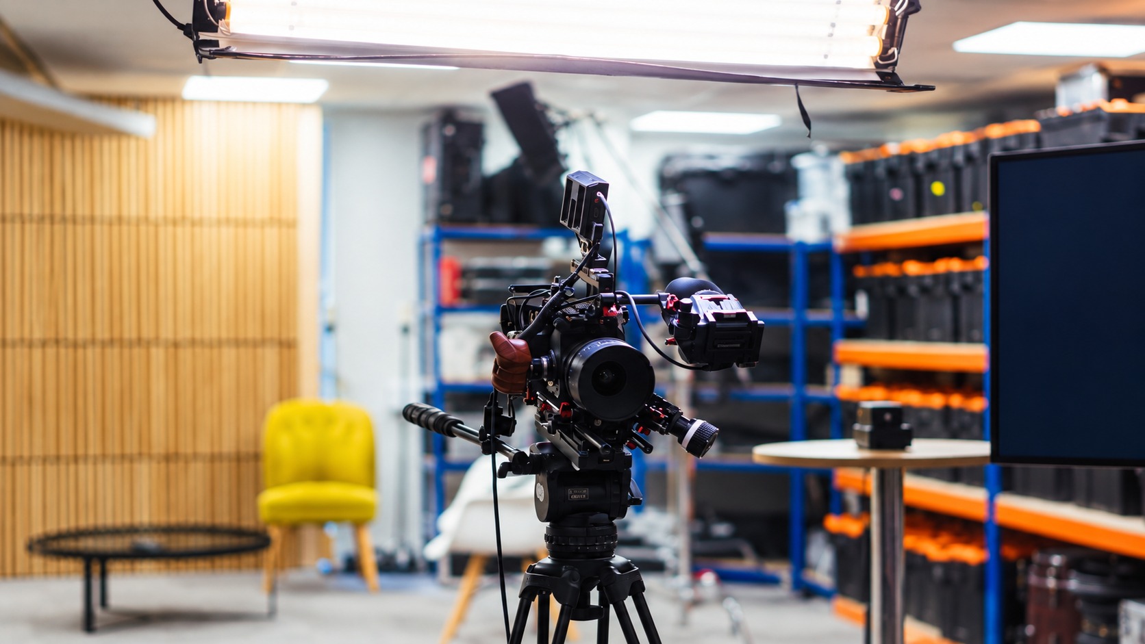 Studio camera on a tripod illustrating the production of exclusive product photos