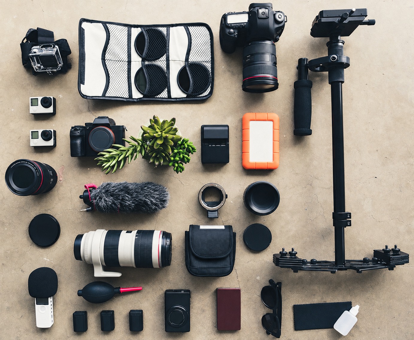 Separate cameras, lenses and stabilizer on a tabletop illustrating that proximity does not establish working compatibility