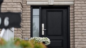 Black residential door and blurred foreground sign illustrating a missing parcel location question