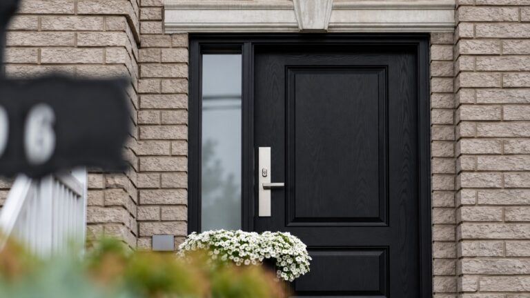 Black residential door and blurred foreground sign illustrating a missing parcel location question
