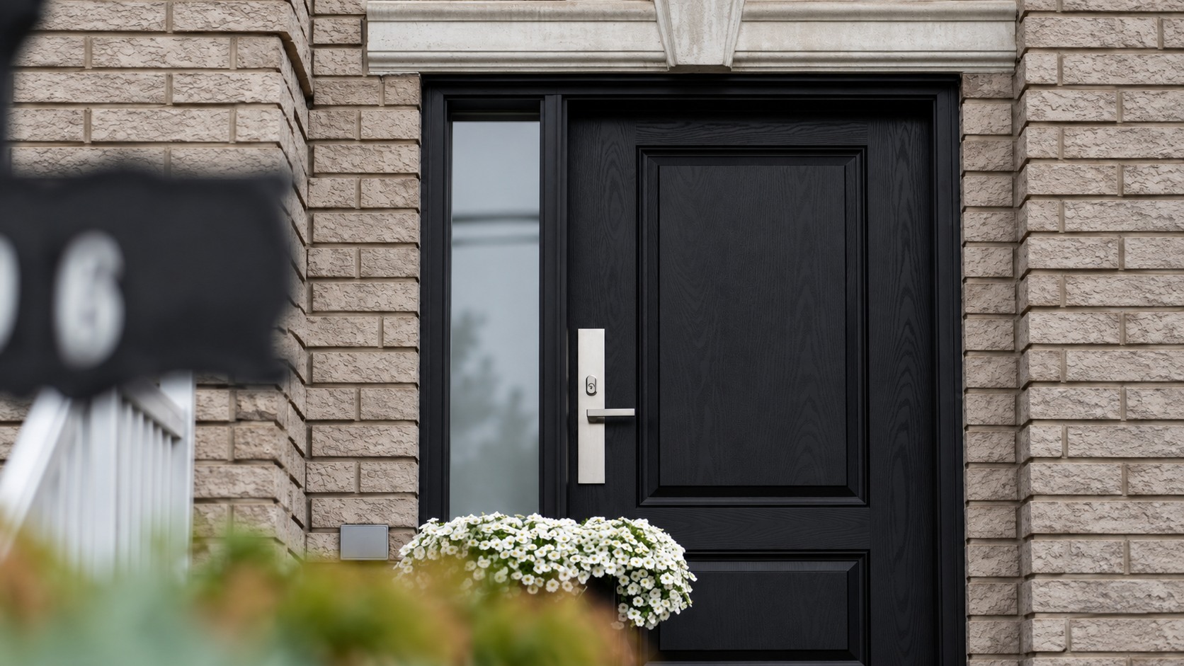 Black residential door and blurred foreground sign illustrating a missing parcel location question