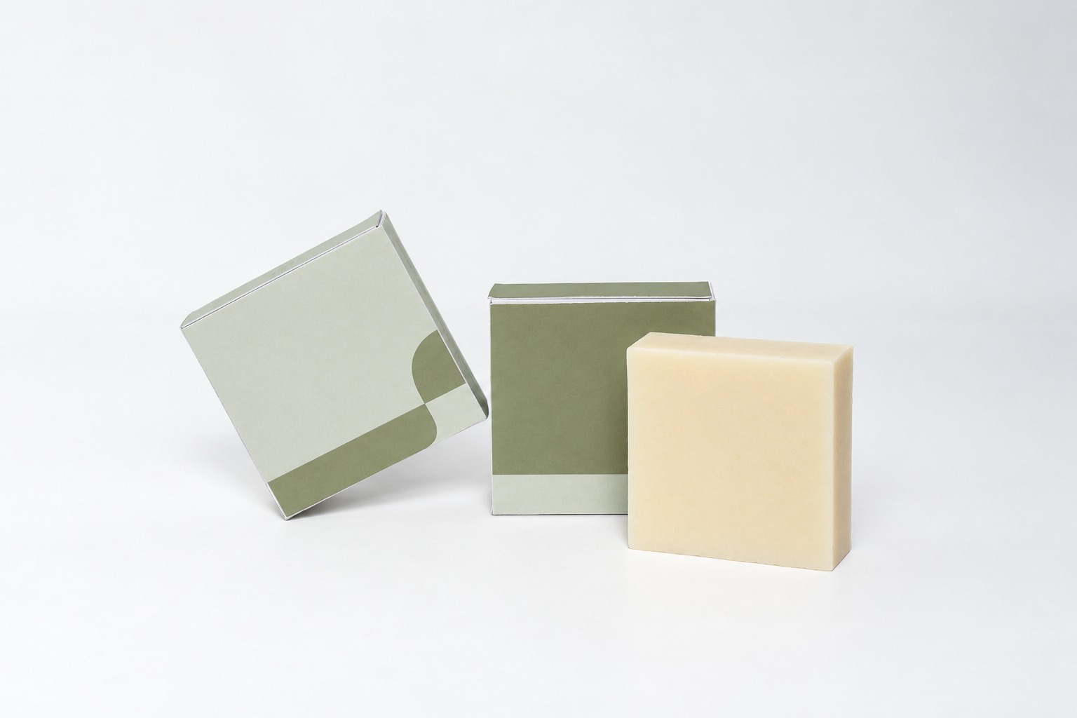 One cream bar beside two plain retail cartons illustrating product and packaging scope