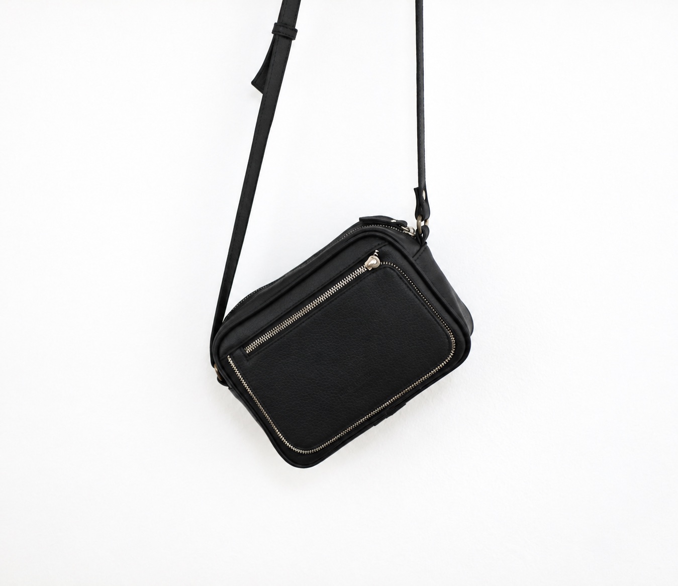 Black bag with a visible strap adjuster and side attachment against a white background