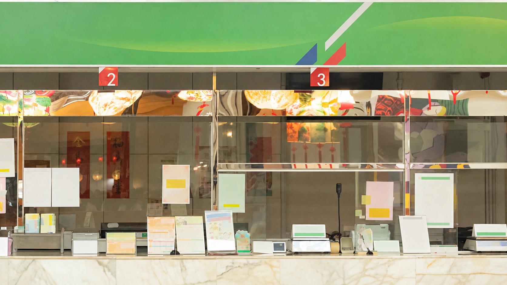 Postal service counter with glass partitions and receiving windows