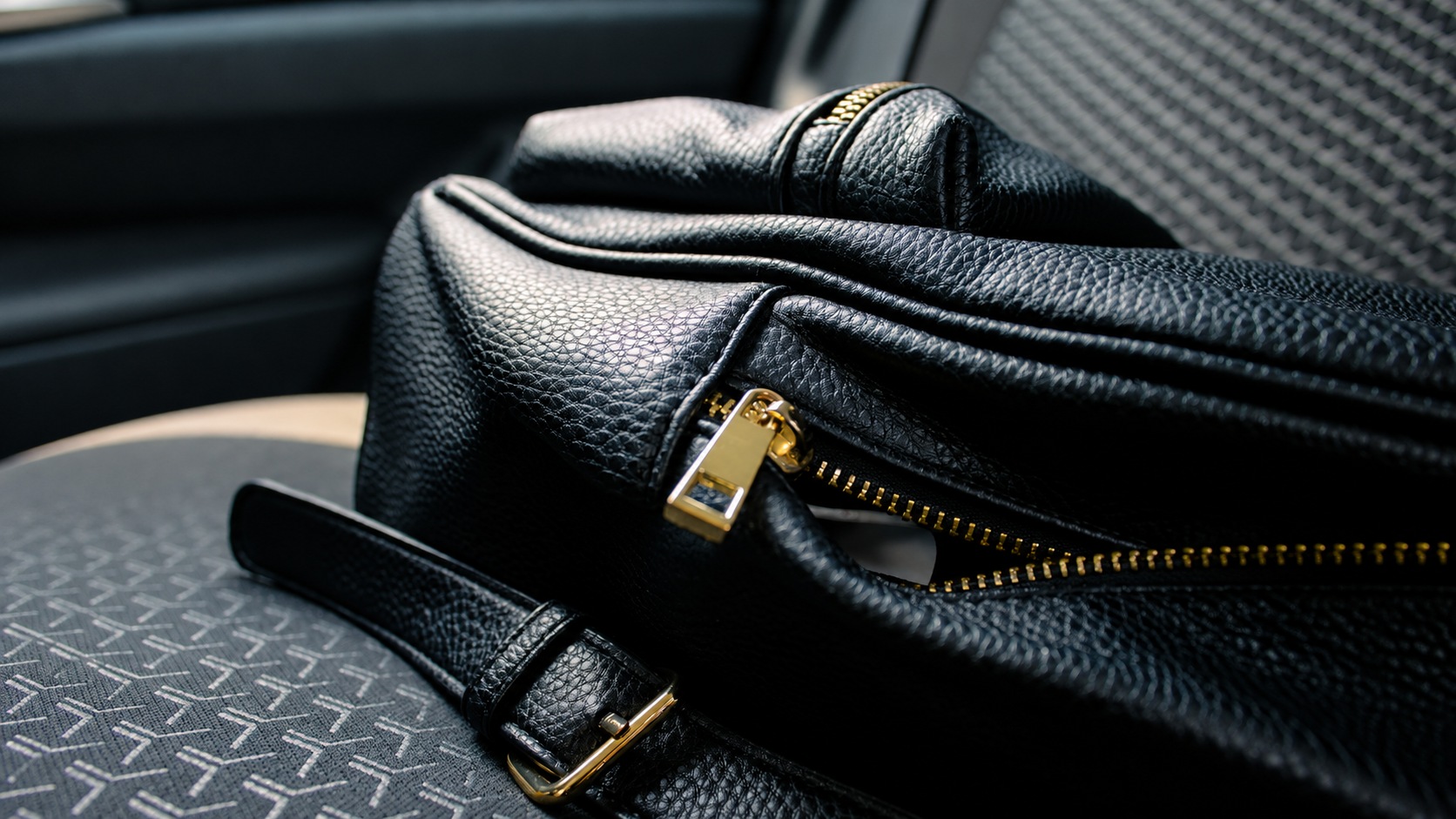 Close view of a black bag zipper and slider in a still photograph