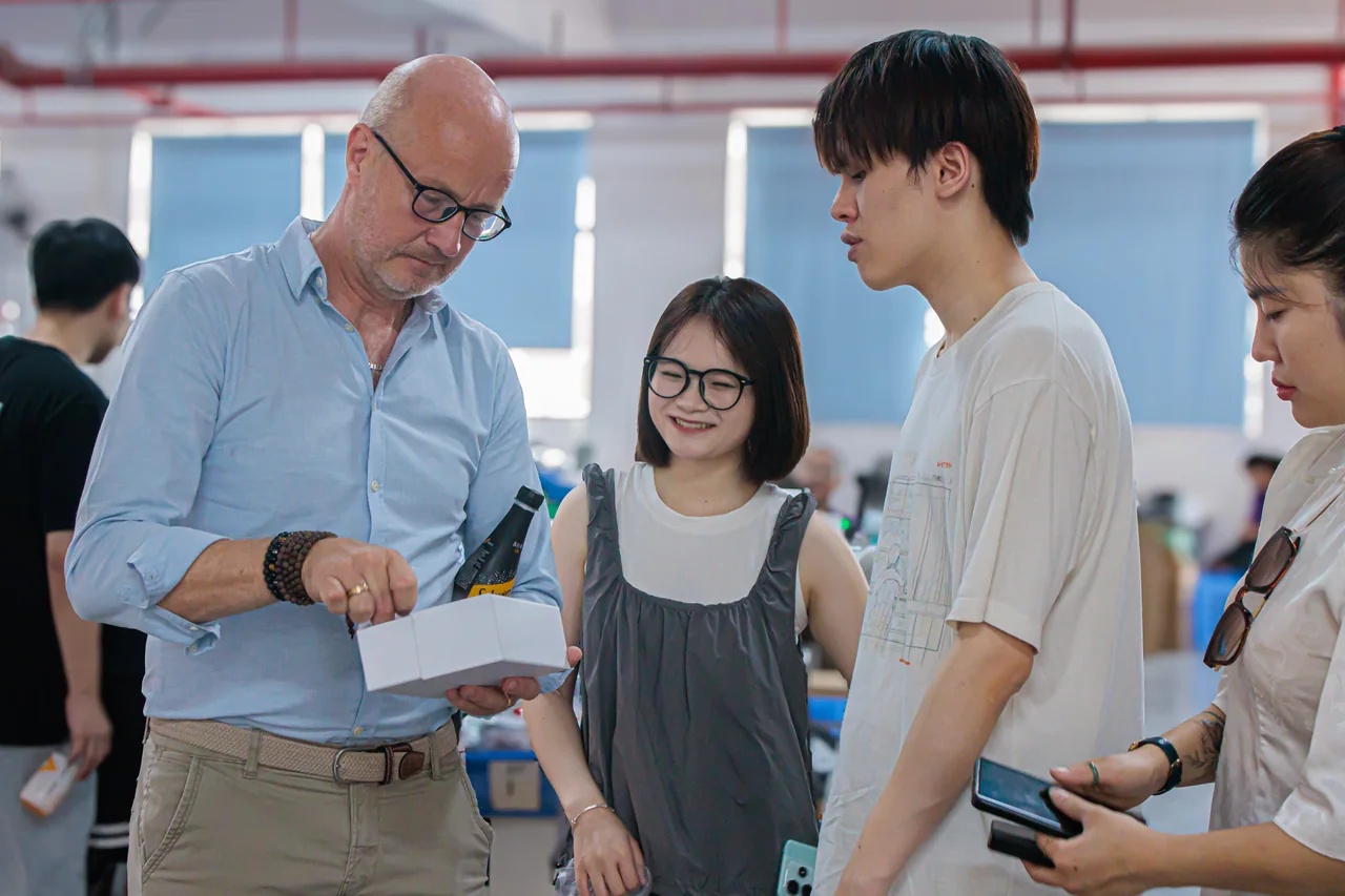 A group looking at a white sample box in the warehouse