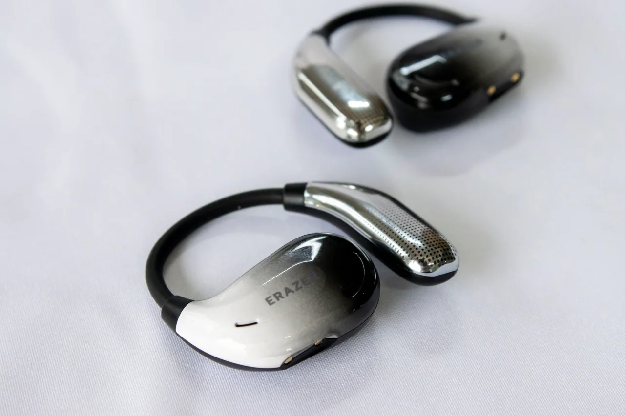 Close-up photograph of a pair of wireless earphones on a white surface